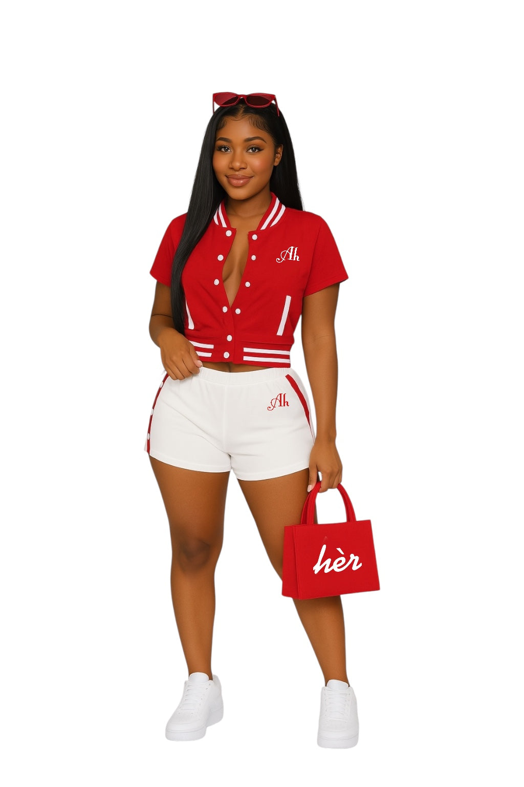 Young African-American woman wearing a red cropped varsity jacket and fitted white shorts, styled with red sunglasses, a red “hèr” purse, and white sneakers, posing confidently against a white background.
